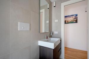 a bathroom with a white sink and a mirror at Luxury Home in Bari +12 photos