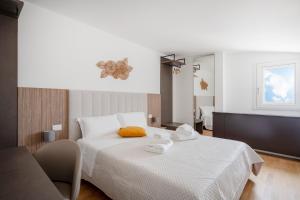 a bedroom with a white bed with towels on it at Luxury Home in Bari