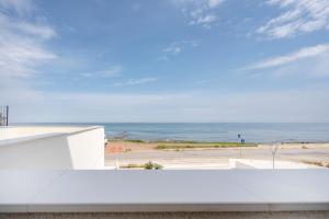 a view of the ocean from a white building at Luxury Home in Bari