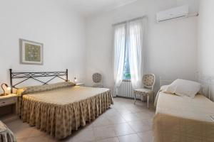 a bedroom with two beds and a window at Affittacamere Borgo Trento in Verona