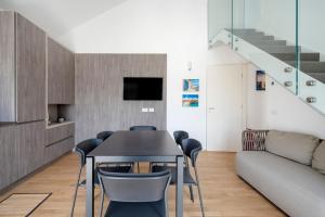 a dining room with a table and chairs and a couch at Luxury Home in Bari