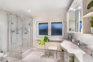 a white bathroom with a shower and a sink at Fuchsbau Voßwinkel in Arnsberg +37 photos