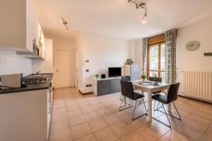 a kitchen and living room with a table and chairs at Villa Bornico Marisa in Toscolano Maderno