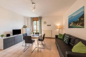 a living room with a couch and a table at Villa Bornico Marisa in Toscolano Maderno