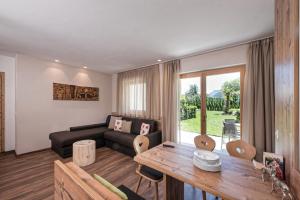 a living room with a couch and a table at Chalet Schaller in Missiano