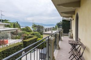 a balcony with benches and a view of the ocean at Villa Bornico Marisa in Toscolano Maderno