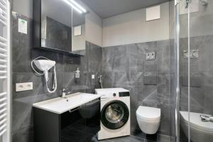 a bathroom with a washing machine and a washer at Hotel zur Panke Wohnung 5 in Kolonie Röntgental +22 photos