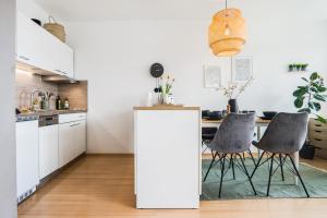 a kitchen with a table and two chairs at Ruhiges und modernes Zuhause in Münster +12 photos