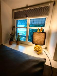a stuffed animal sitting on a bed next to a window at nord-ostseeglück in Ladelund