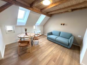 a living room with a blue couch and a table at City Apartments Hannover in Hannover