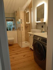 a bathroom with a sink and a washing machine at nord-ostseeglück in Ladelund +17 photos