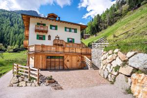 a large house with a wooden door on a hill at La Chiasa in Rabbi