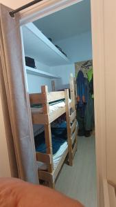 ajar view of a room with bunk beds at Appartement 4 pers Montagne -draps et serviettes non fournis- in Eaux-Bonnes