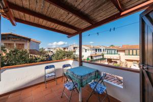 a patio with a table and chairs on a balcony at Via Mazzini 87 in Calasetta