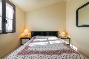 a bedroom with a large bed with two night stands at Via Mazzini 87 in Calasetta