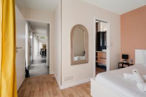 a bedroom with a bed and a mirror on the wall at Villa de standing piscine 10 pers in Bruz +28 photos