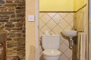 a bathroom with a white toilet and a sink at Miradoiro do Courel - Millares in Campelo +25 photos