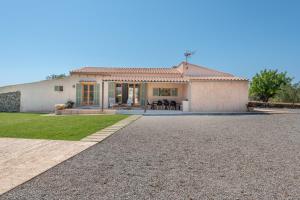 a house with a gravel driveway in front of it at Finca Laurel in Islas Baleares