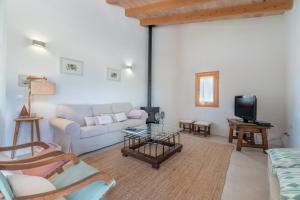 a living room with a couch and a tv at Finca Laurel in Islas Baleares