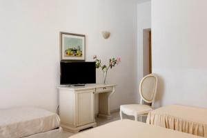 a room with a desk with a television on it at Affittacamere Borgo Trento in Verona +84 photos