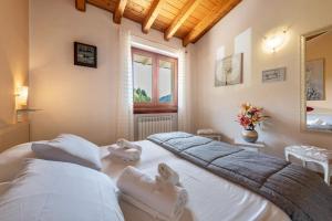 a bedroom with two beds and a window at Residence Tatiana B1 in Tremosine Sul Garda +24 photos