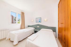 a hospital room with two beds and a window at Oro del Mar iv apartamento 05 in Canyamel +21 photos