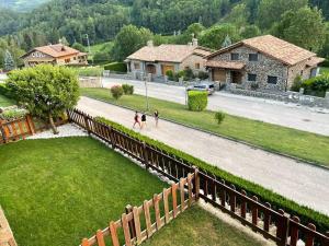 two people walking down a road next to a house at El Mirador de Llanars in Llanars