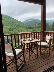 a table and chairs on a deck with a view at El Mirador de Llanars in Llanars +17 photos