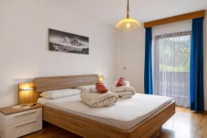 a bedroom with a bed with two pillows on it at Schnellehof in Velturno