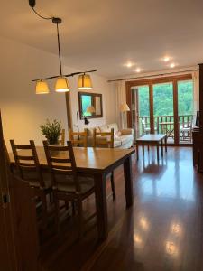 a living room with a dining room table and chairs at El Mirador de Llanars in Llanars