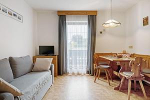 a living room with a couch and a table at Schnellehof in Velturno