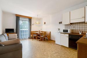 a kitchen and living room with a couch and a table at Schnellehof in Velturno