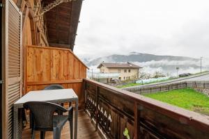 a balcony with two chairs and a table on it at Schnellehof in Velturno