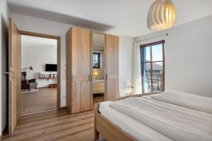 a bedroom with a large bed and a large mirror at Wohnung Untersbergblick in Freilassing