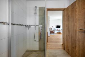 a bathroom with a shower with a glass door at Wohnung Untersbergblick in Freilassing +25 photos