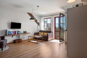 a living room with a couch and a tv at Wohnung Untersbergblick in Freilassing