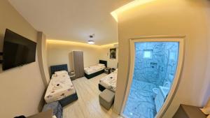 a hospital room with two beds and a window at London Restaurant Hotel in Kukës