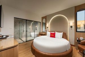 a bedroom with a large bed and a bathroom at Lam Anh Hotel 10 Ngoai Giao Doan in Hanoi +26 photos