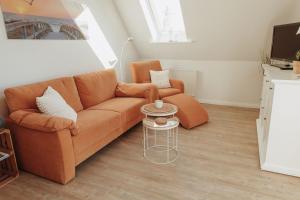 a living room with a couch and a table at Gästehaus Bröcker Wohnung 8 in Büsum