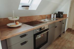 a kitchen with a sink and a counter top at Gästehaus Bröcker Wohnung 8 in Büsum +10 photos