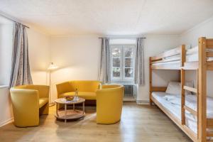 a room with two bunk beds and a table and chairs at Gasthaus Hirschen Holl in Elbenschwand