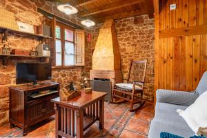 a living room with a couch and a tv at Lolo in Villaviciosa +15 photos
