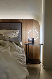 a bed with a round mirror on a table next to it at Truma Swing Luxury in Merano