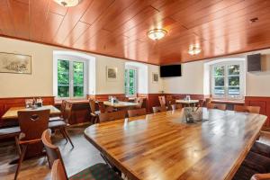 a dining room with a large wooden table and chairs at Gasthaus Hirschen Holl in Elbenschwand