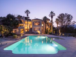 a large house with a swimming pool in front of it at Villa Rocca in La Herradura