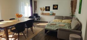 a living room with a couch and a table at E"STEIN 3 ZKB Balkon in Koblenz