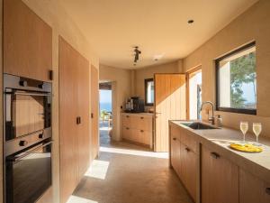a kitchen with a sink and a counter with wine glasses at Villa Rocca in La Herradura