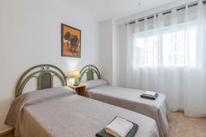 a room with two beds and a window at Isabela in Calpe