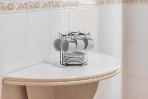 a pile of dishes on top of a toilet in a bathroom at Isabela in Calpe +16 photos