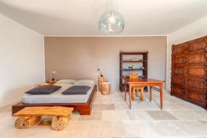 a bedroom with a bed and a table and a desk at La casa di Rollo in Otranto
